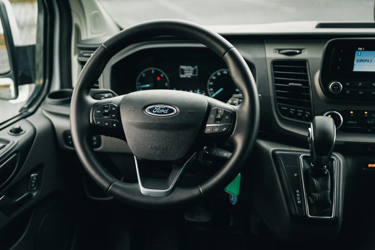 the interior of a car with a steering wheel and dashboard